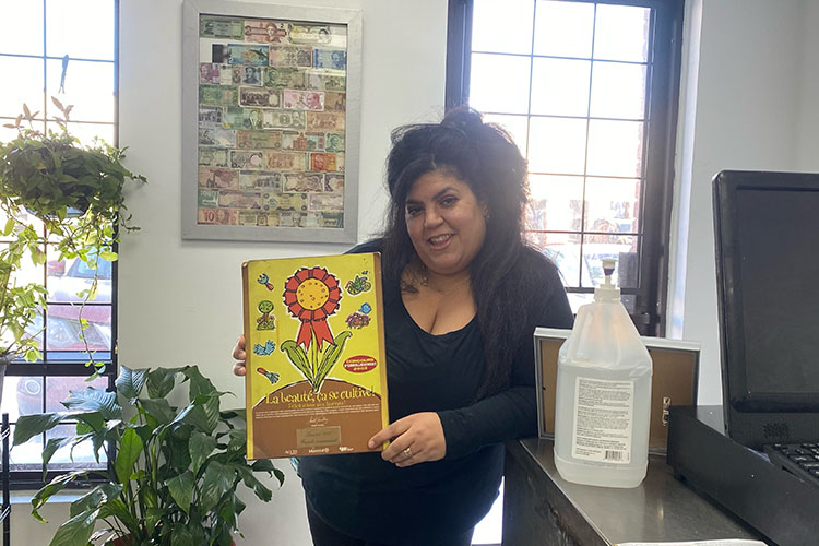 Nilufar Al-Shourbaji holding an award sign.