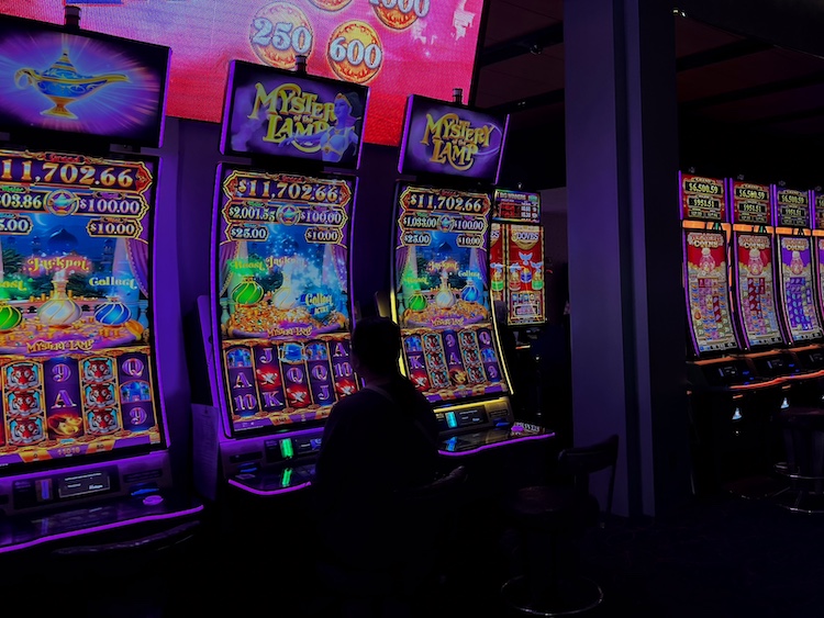 A player sits in the glow of slot machines at the Montreal Casino, chasing the chance of a big win.