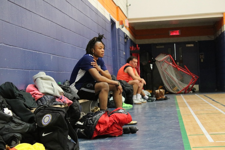 Marvens is waiting on a bench for his turn to play soccer.