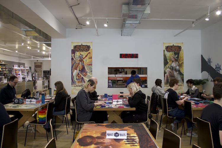 Three tables filled with players competing in a Netrunner championship.