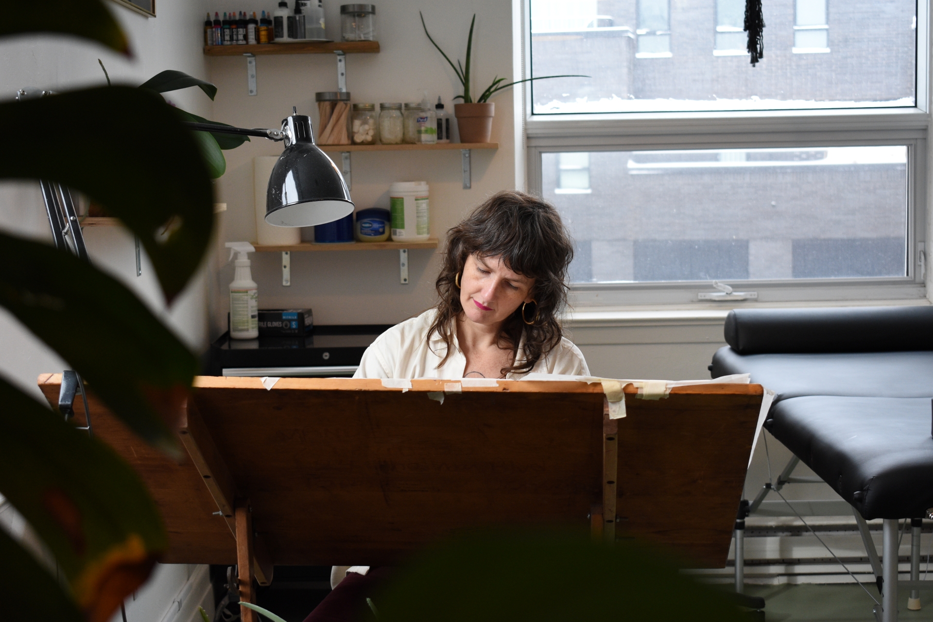 Owner of Catalpa Studio Kae Nine Fingers works on tattoo designs