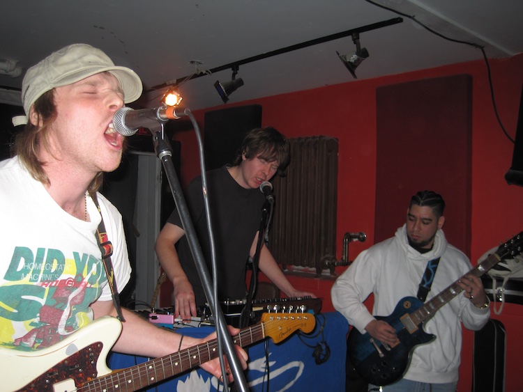 up-close of three band members during the performance