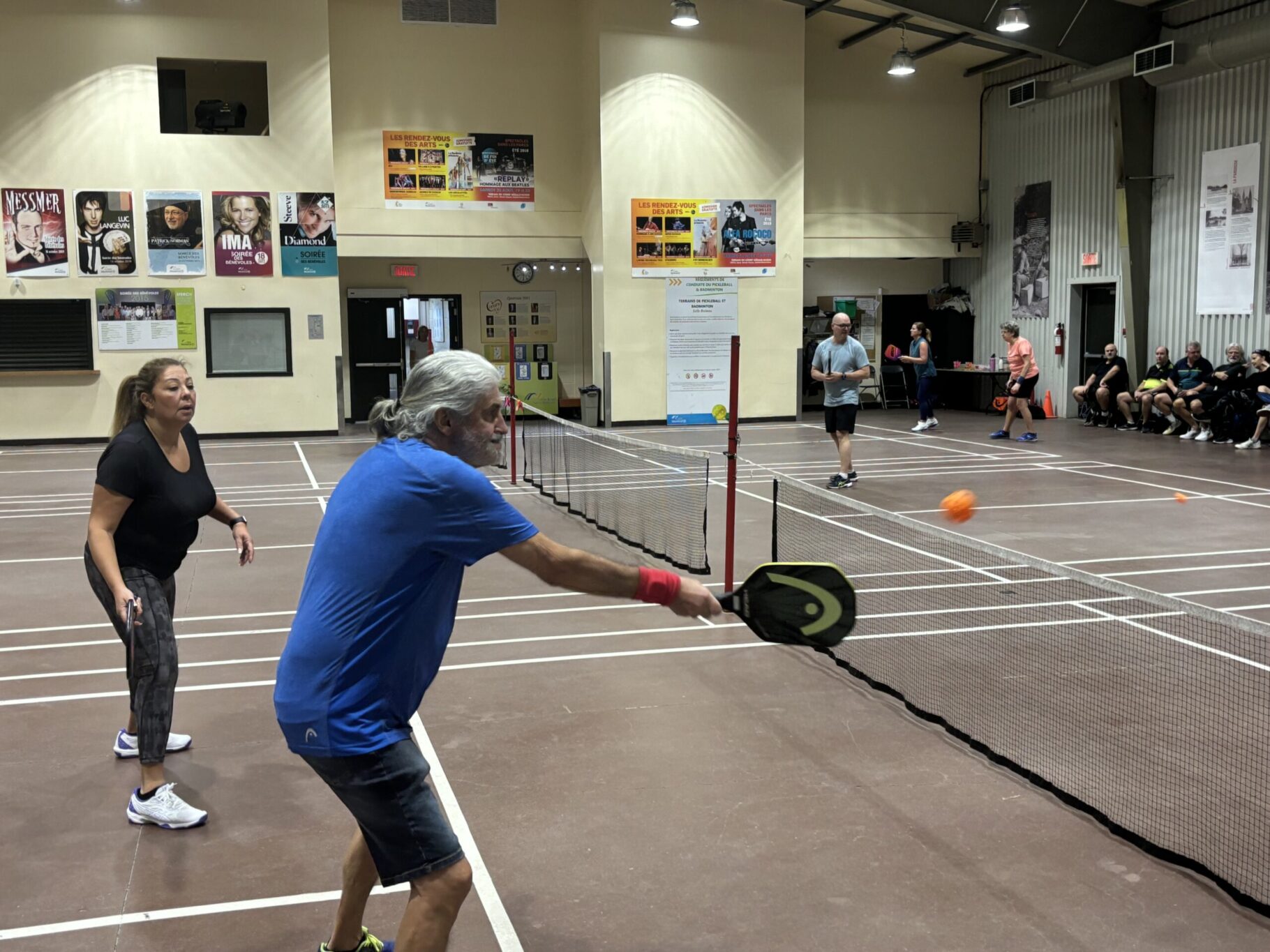Two people play pickleball