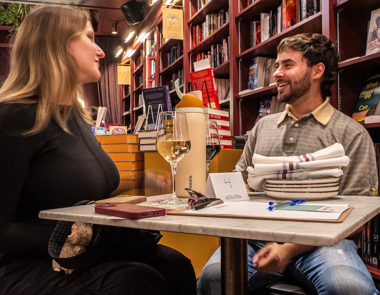 A group discussing during a trivia night hosted by the Joie de Livres bookstore