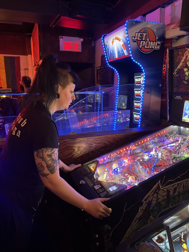 Bartender playing pinball